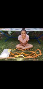young girl with giant dipper replica made with tickets