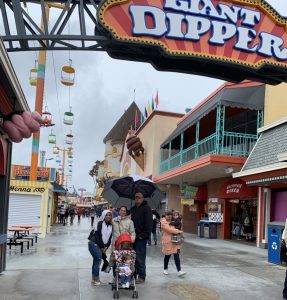 family standing under giant dipper sign